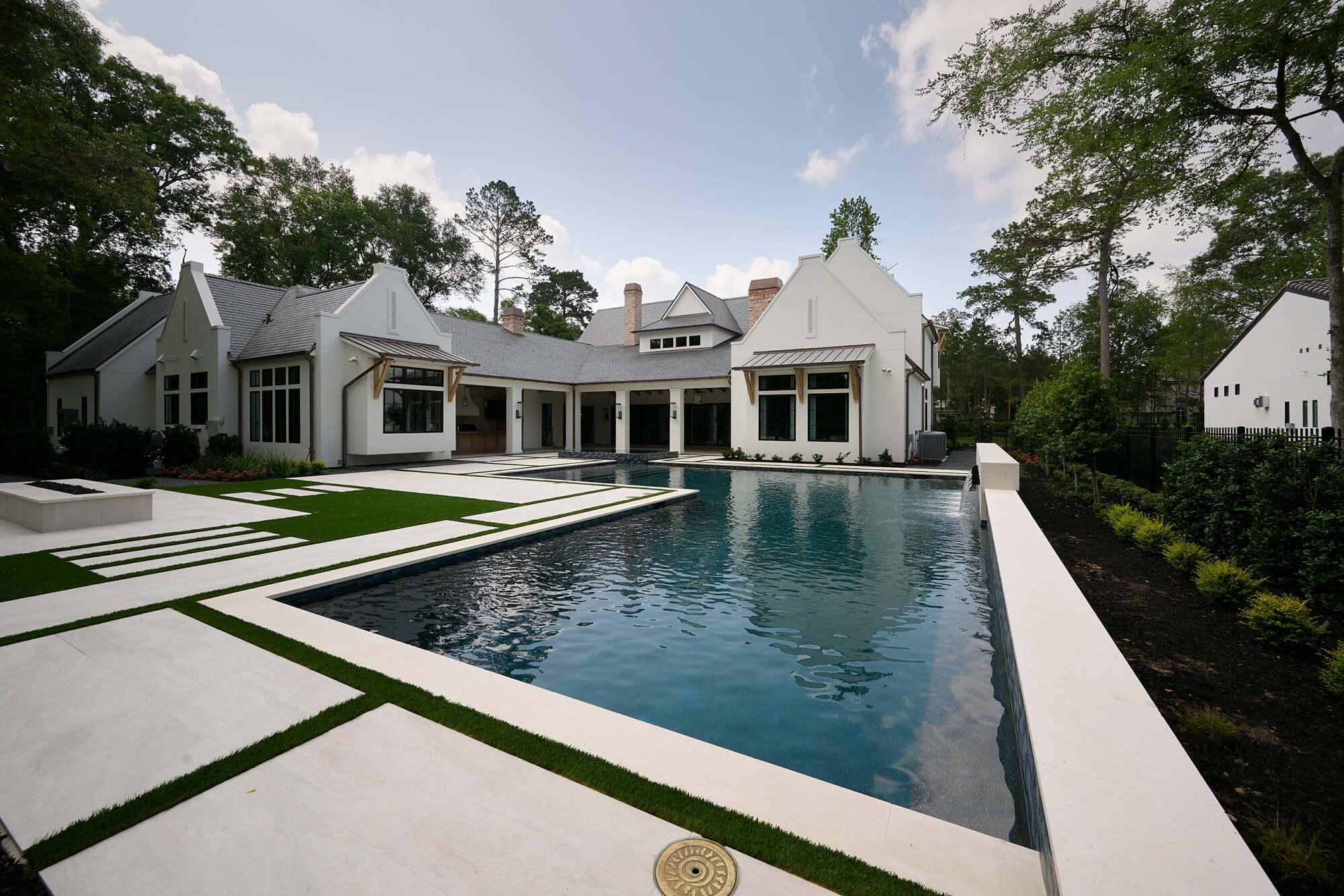 outdoor pool and spa with water features on a hot sunny day